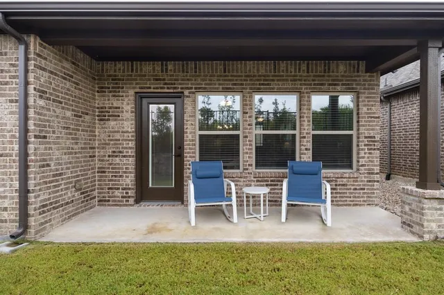 a backyard of a house with table and chairs