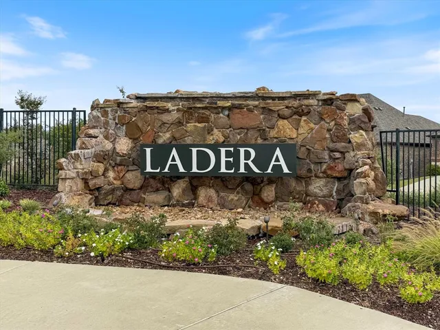 a view of a sign board with buildings