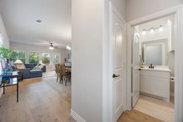 a view of a livingroom and a dining room with furniture window and wooden floor