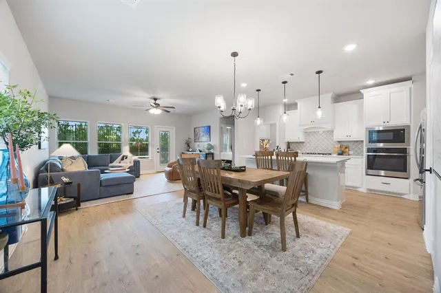 a large kitchen with a table and chairs