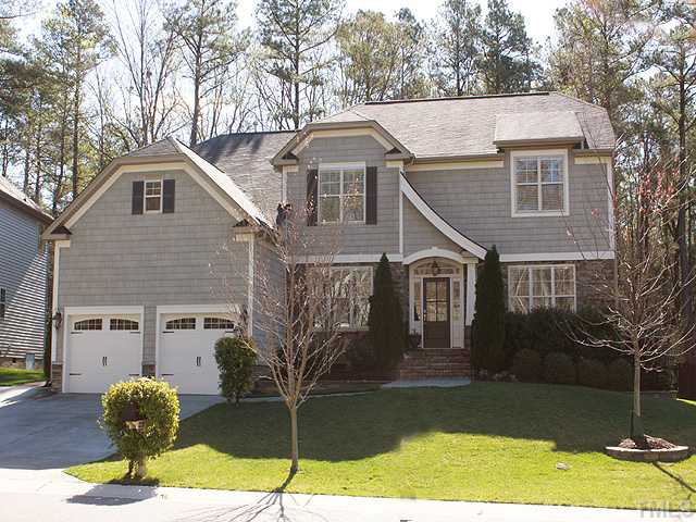 8232 Clarks Branch Drive Raleigh, NC 27613 - Photo 1 of 11 a front view of a house with garden