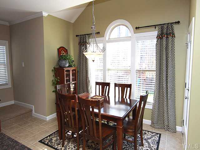 8232 Clarks Branch Drive Raleigh, NC 27613 - Photo 3 of 11 a view of a dining room with furniture and a window