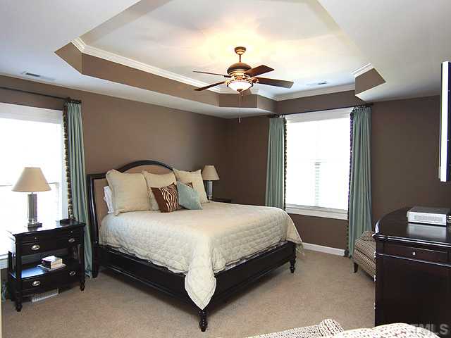 8232 Clarks Branch Drive Raleigh, NC 27613 - Photo 8 of 11 a bedroom with a bed and a chandelier