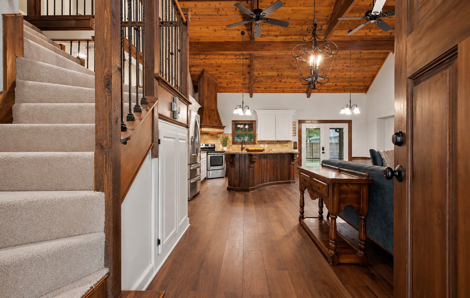 312 Springwood Drive Conroe, TX 77385 - Photo 8 of 50 The grand entry opens to soaring ceilings accented by wood beams that add warmth and character.