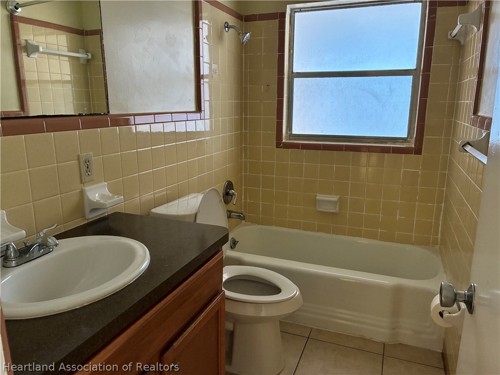 1525 Lagrange Avenue Sebring, FL 33870 - Photo 8 of 16 a bathroom with a sink a toilet and shower