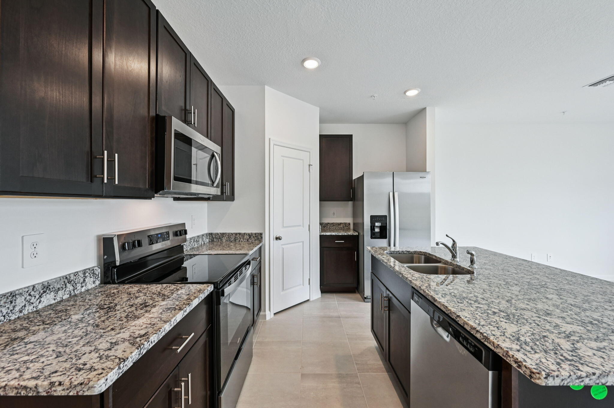 475 Salisbury Circle Fort Pierce, FL 34982 - Photo 11 of 30 a kitchen with stainless steel appliances granite countertop a sink stove and refrigerator