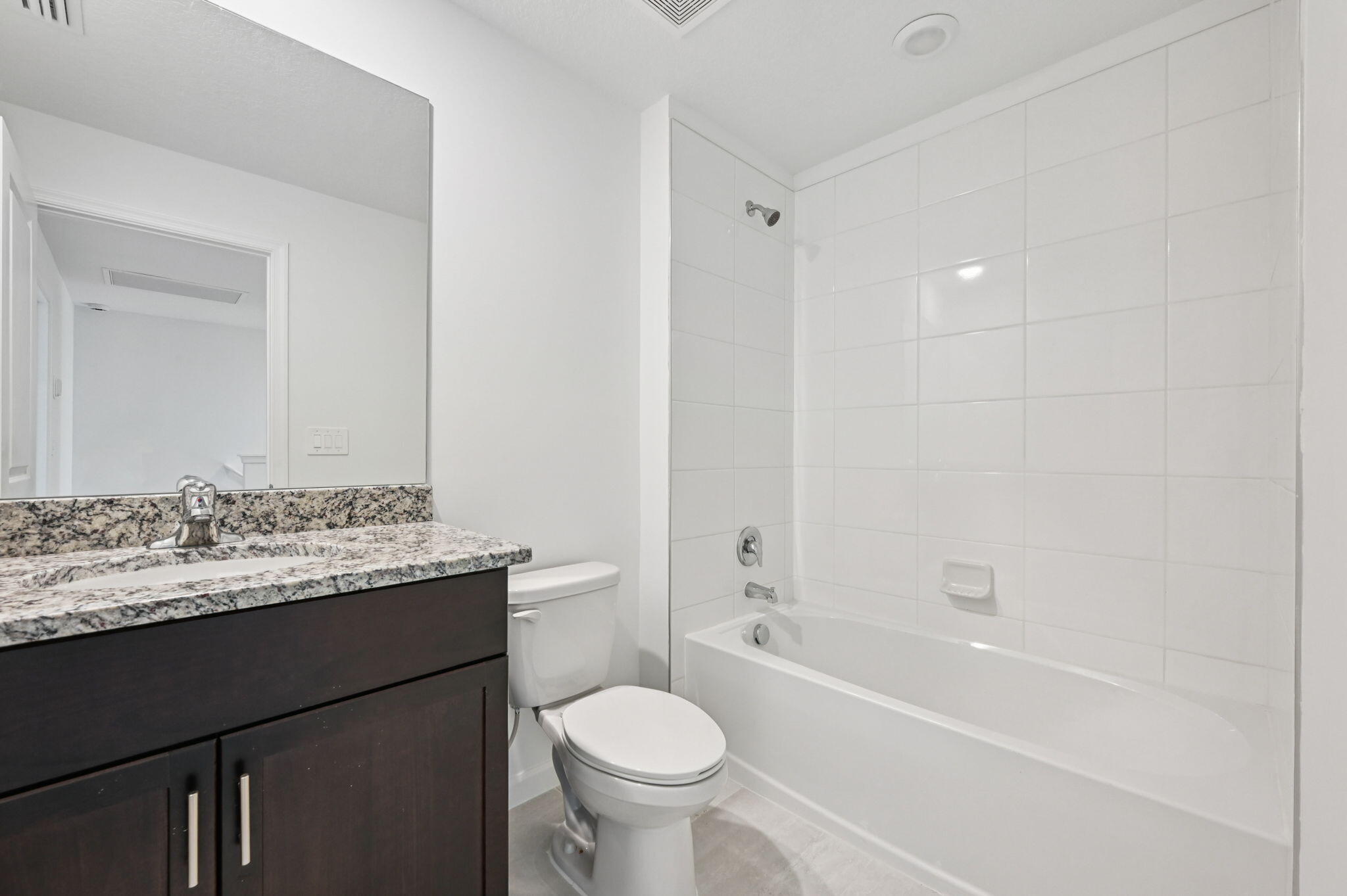 475 Salisbury Circle Fort Pierce, FL 34982 - Photo 19 of 30 a bathroom with a granite countertop sink toilet mirror and bathtub
