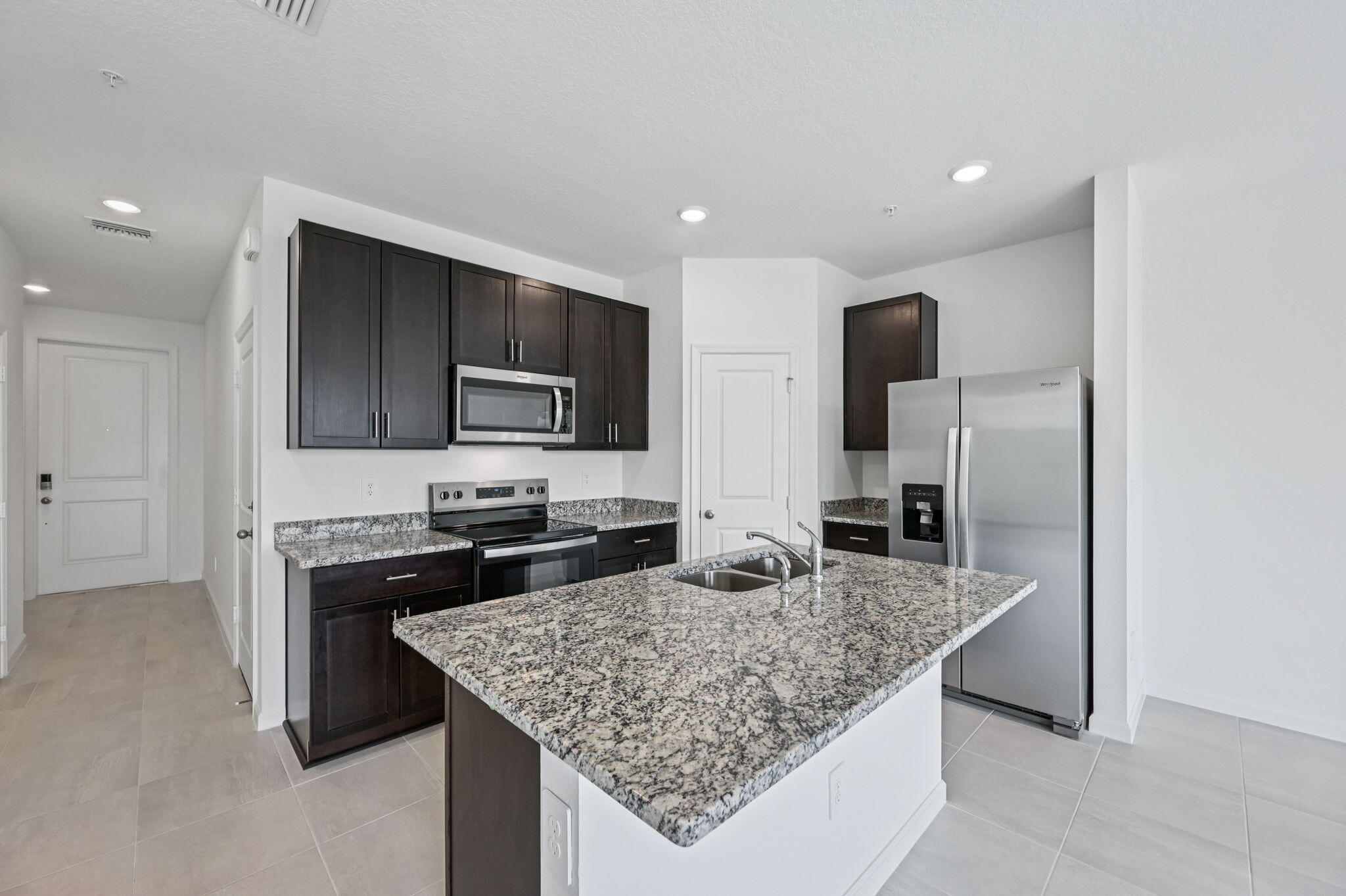 475 Salisbury Circle Fort Pierce, FL 34982 - Photo 9 of 30 a kitchen with stainless steel appliances granite countertop a sink refrigerator and microwave