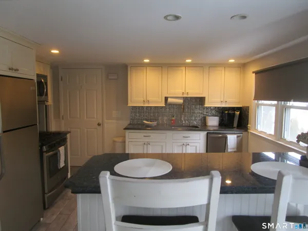 a kitchen with a dining table and chairs