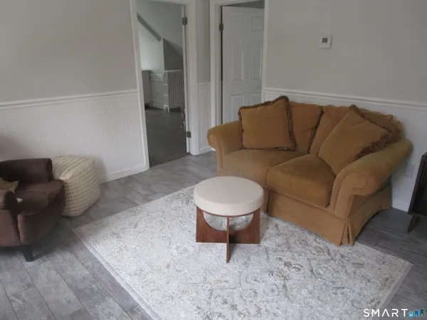 a living room with furniture and a rug