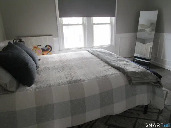 a bedroom with a bed and window