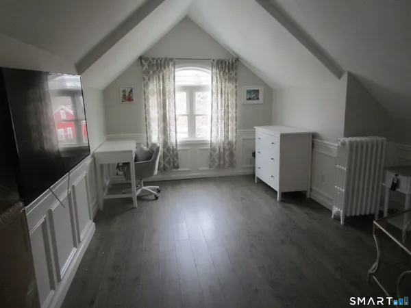 a view of a livingroom with furniture and a window
