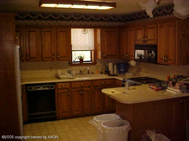 4420 South Ong Street Amarillo, TX 79110 - Photo 7 of 12 a kitchen with a sink stove and microwave