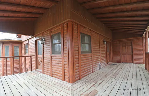 a view of wooden balcony with wooden floor