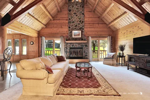 a living room with fireplace furniture and a flat screen tv