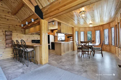 a view of a dining room with furniture window and outside view