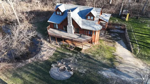 a aerial view of a house with table and chairs