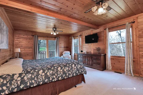 a bedroom with a large bed and a large window