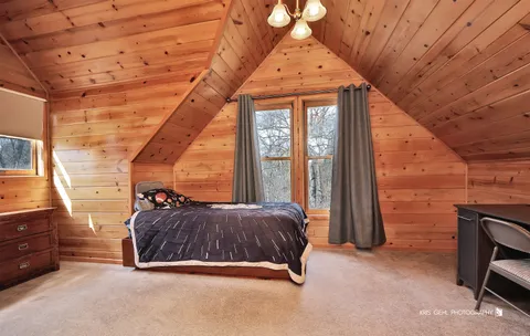 a bed sitting in a room next to a window