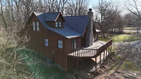 a view of a house with backyard and deck