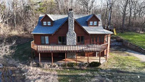a view of a house with a yard and furniture
