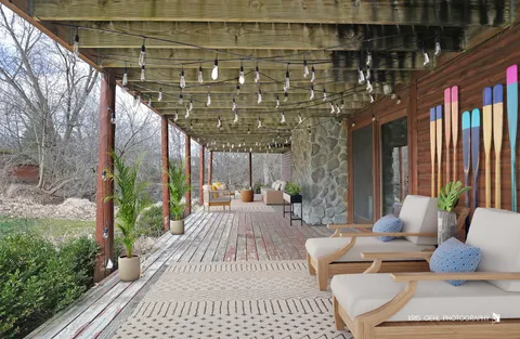 a view of a patio with couches table and chairs and potted plants