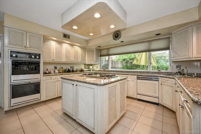 a kitchen with a stove sink and microwave