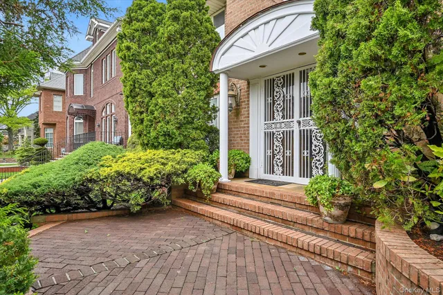 a front view of a house with a garden