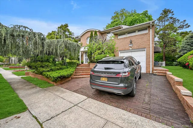 a view of a small car in front of a house