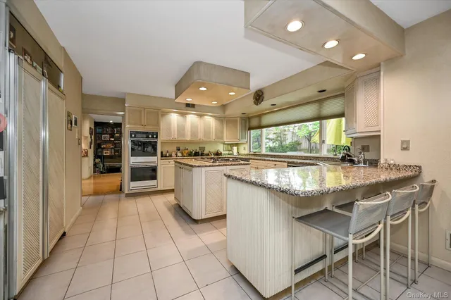 a kitchen with stainless steel appliances granite countertop a stove and a refrigerator