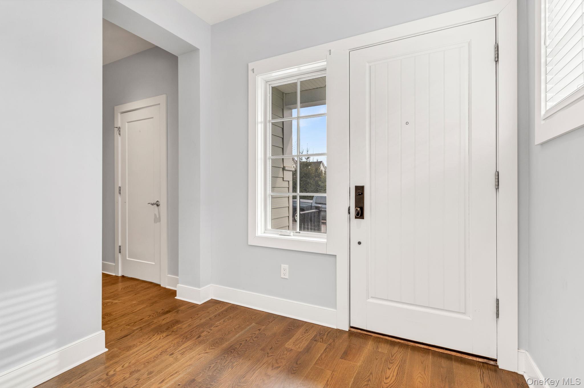 21 Honeysuckle Lane Rye Brook, NY 10573 - Photo 12 of 48 an empty room with wooden floor and windows