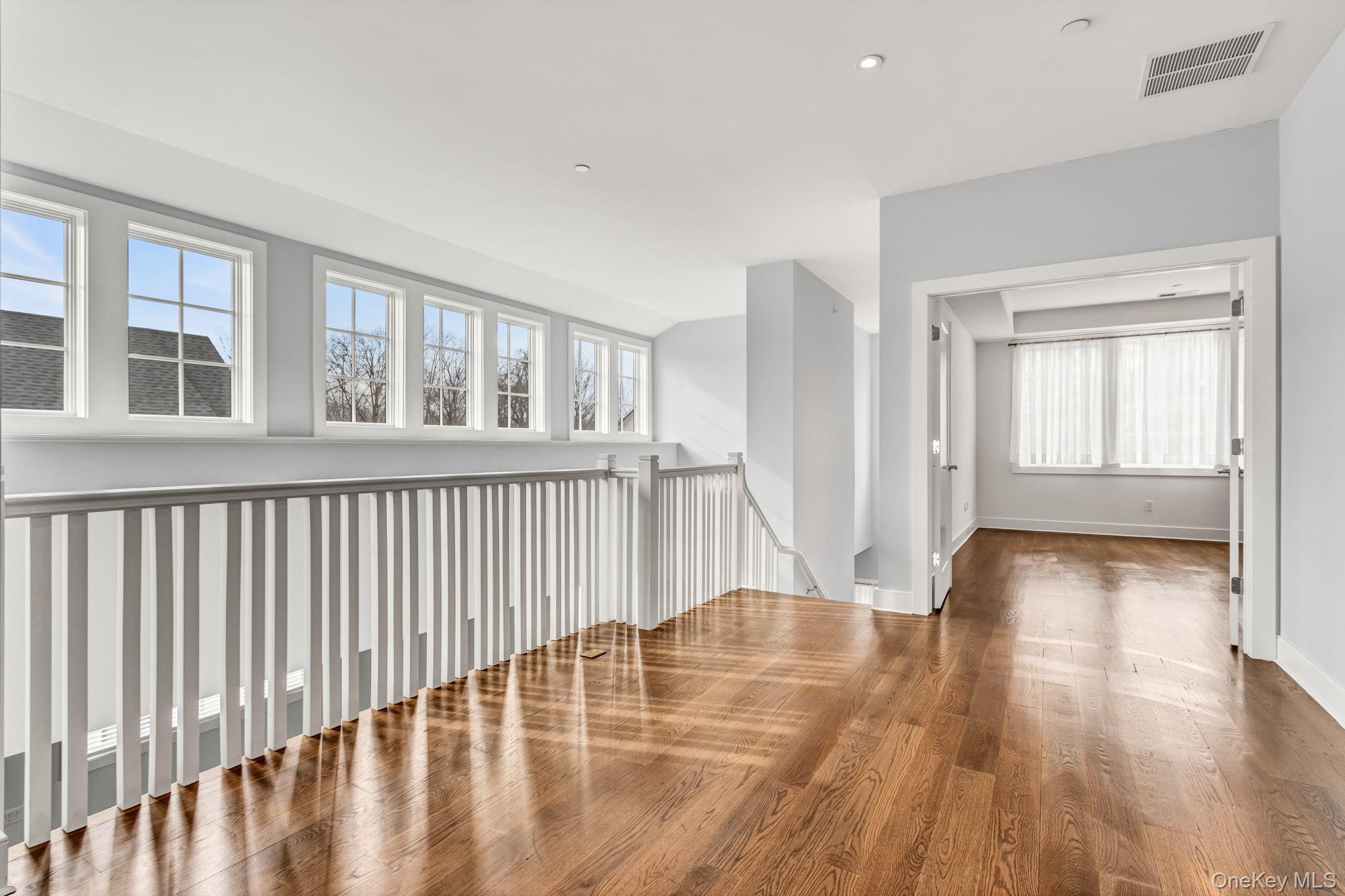 21 Honeysuckle Lane Rye Brook, NY 10573 - Photo 20 of 48 a view of an empty room with wooden floor and a window