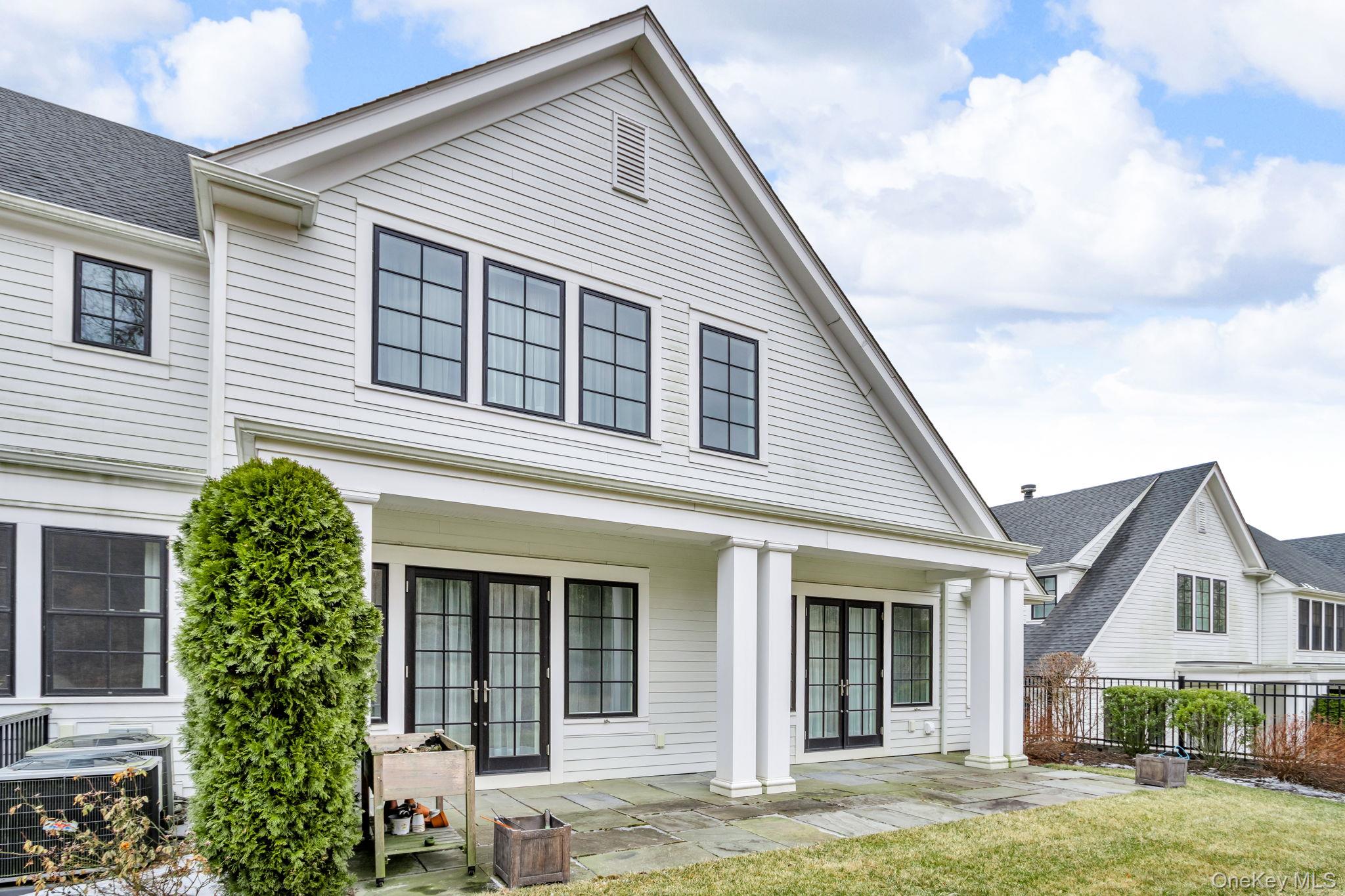 21 Honeysuckle Lane Rye Brook, NY 10573 - Photo 37 of 48 a view of a white house next to a yard