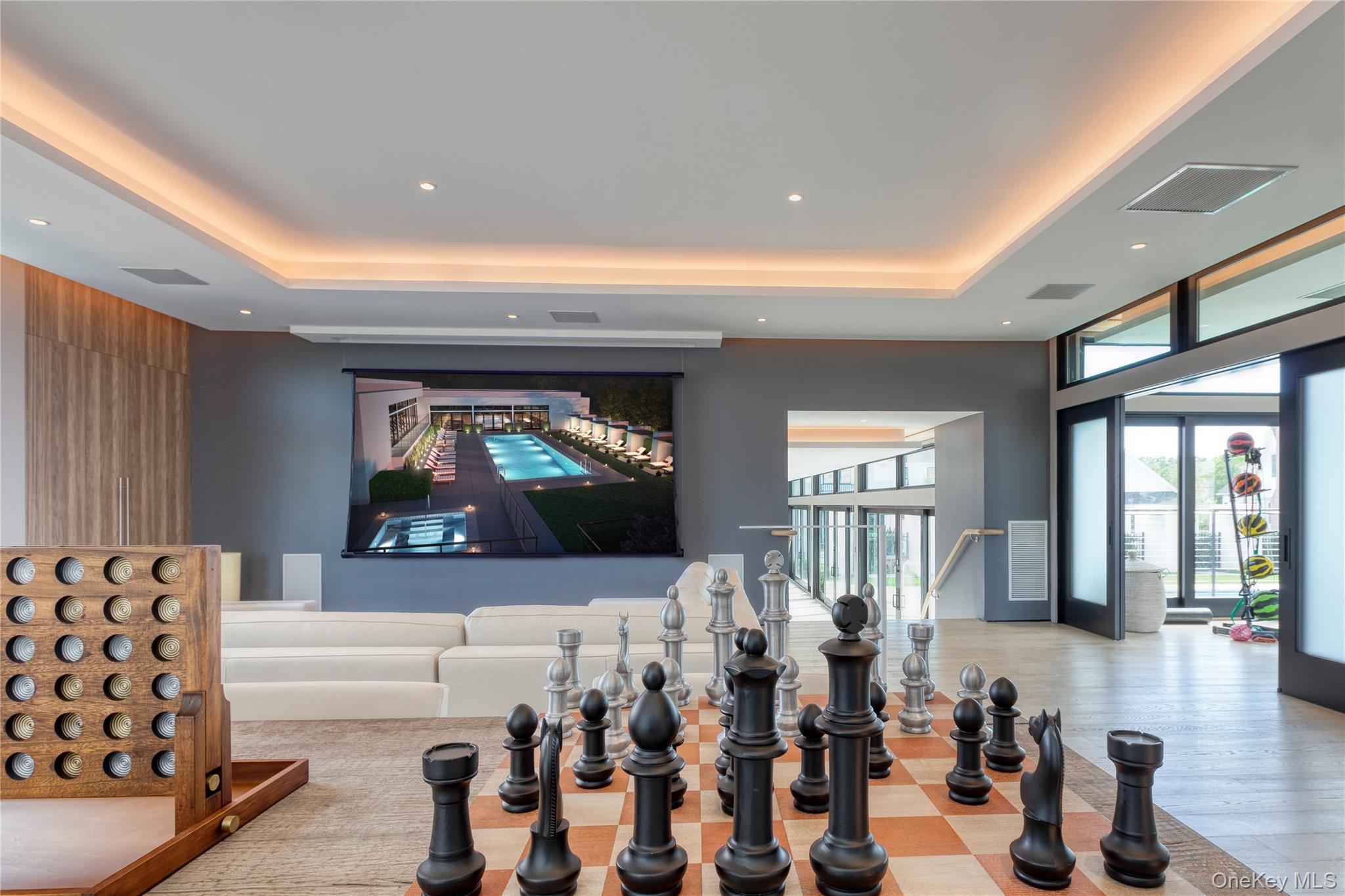 21 Honeysuckle Lane Rye Brook, NY 10573 - Photo 45 of 48 a living room with furniture a flat screen tv and floor to ceiling window