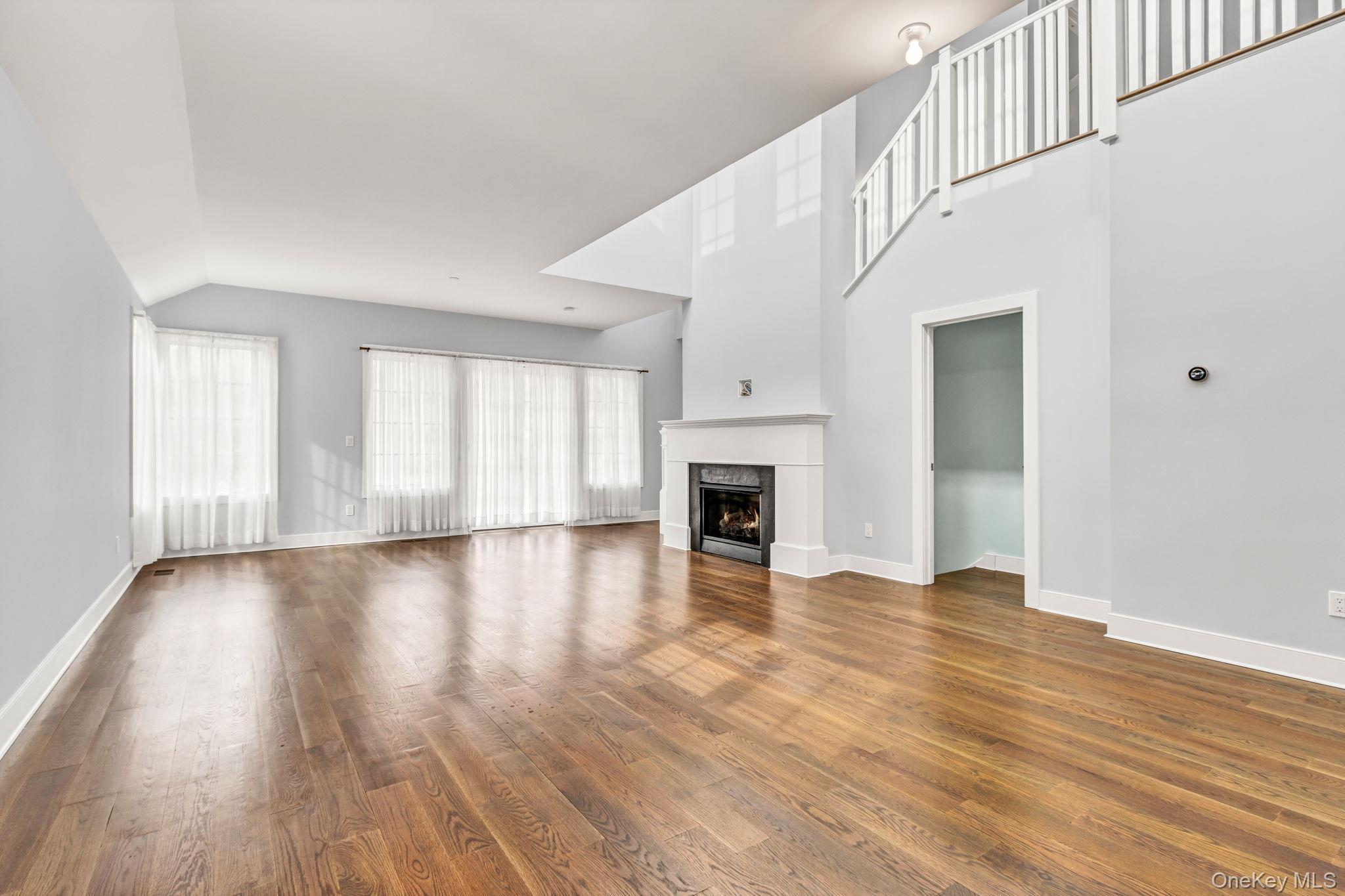 21 Honeysuckle Lane Rye Brook, NY 10573 - Photo 9 of 48 a view of an empty room with wooden floor and a window