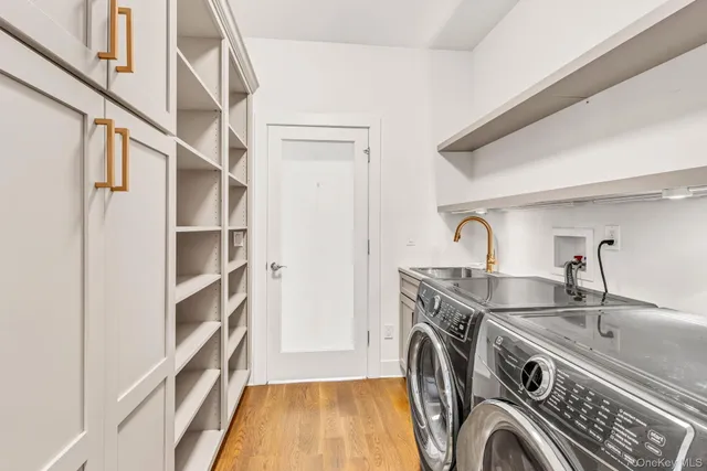 a view of a kitchen with washing machine and a sink