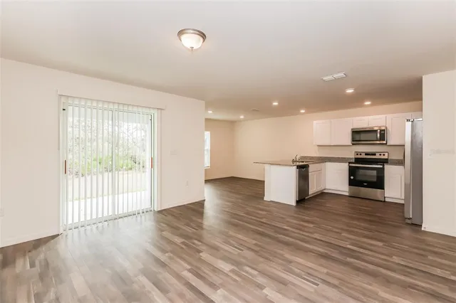 a view of kitchen with wooden floor