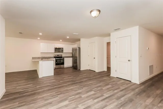 a view of kitchen with wooden floor