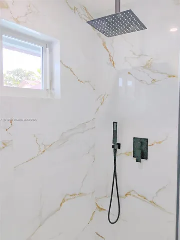 a kitchen with white cabinets and sink