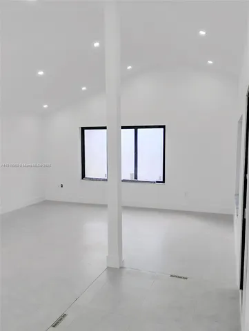 a view of a room with windows and closet