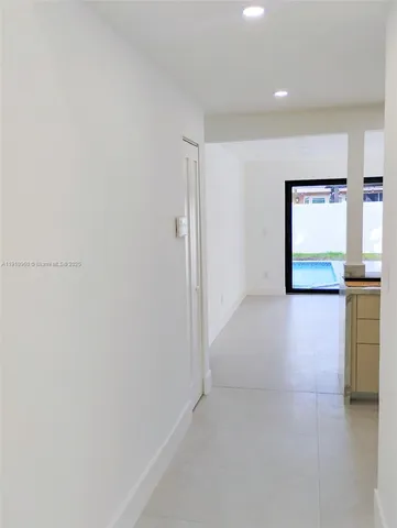 a large white kitchen with a stove a sink and a refrigerator