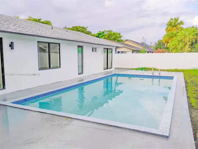 swimming pool view with a outdoor seating space