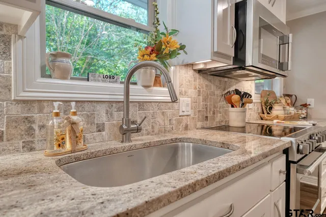 a kitchen with stainless steel appliances a refrigerator and wooden floor