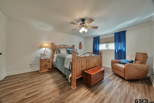 a spacious bedroom with a bed and a ceiling fan