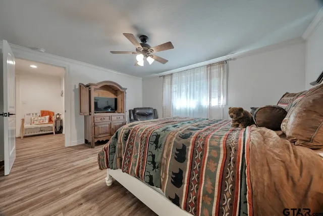 a bedroom with a bed and a chandelier