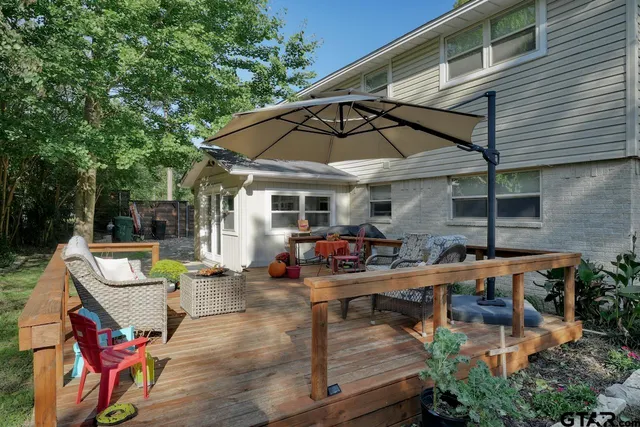 a view of a backyard with a bench and a tree