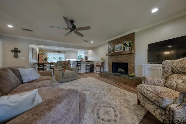 a living room with furniture a fireplace and a flat screen tv