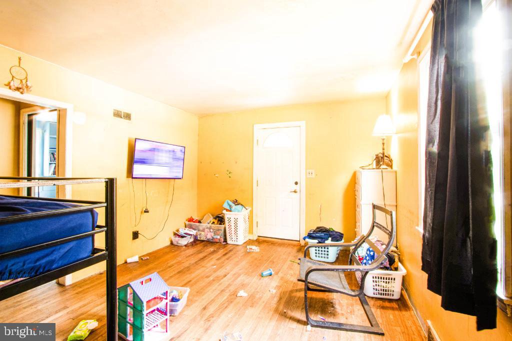 719 Wampler Road Baltimore, MD 21220 - Photo 15 of 18 a bedroom with a bed and wooden floor