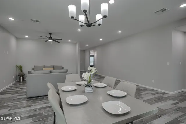 a kitchen with a dining table chairs and microwave