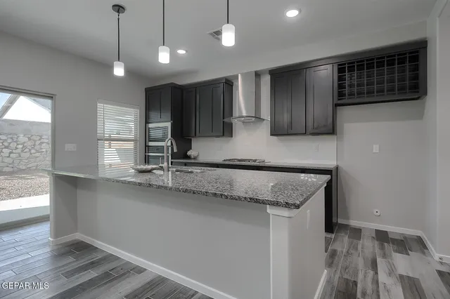 a kitchen with stainless steel appliances a refrigerator and a sink